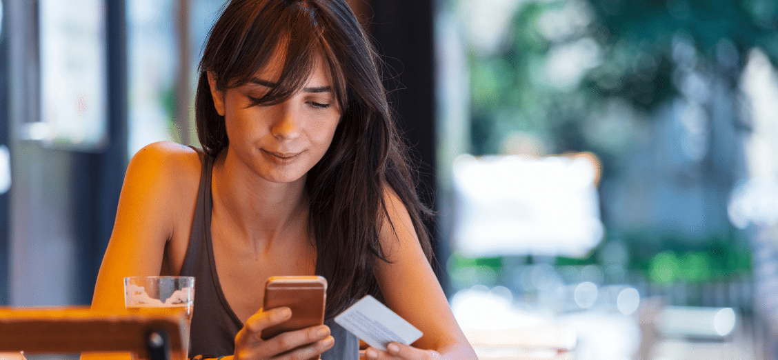 CIAM and Identity Orchestration featured image - Strata.io Woman looking at her phone